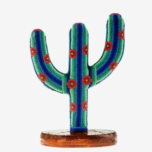 A cactus with red flowers on top of it.