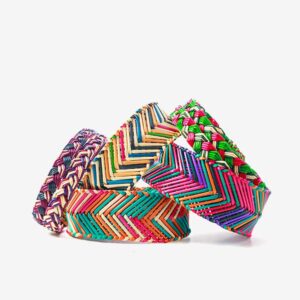 A group of colorful bracelets sitting on top of each other.