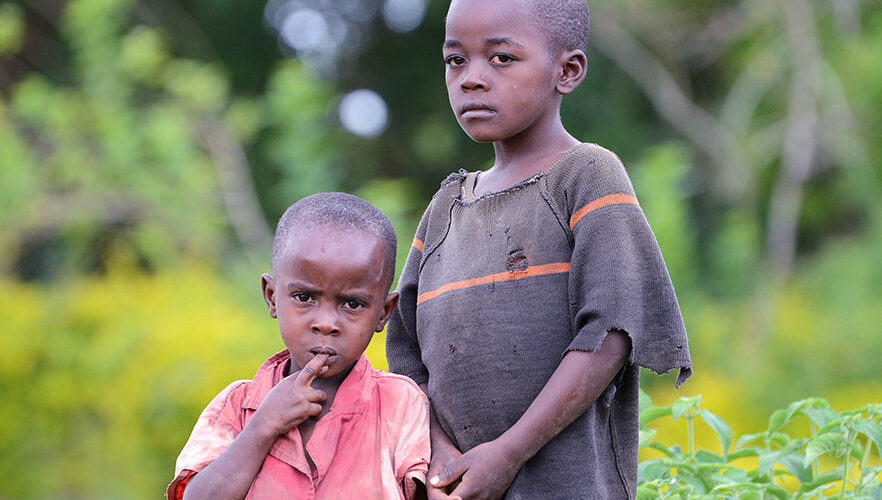 Two young boys standing next to each other.
