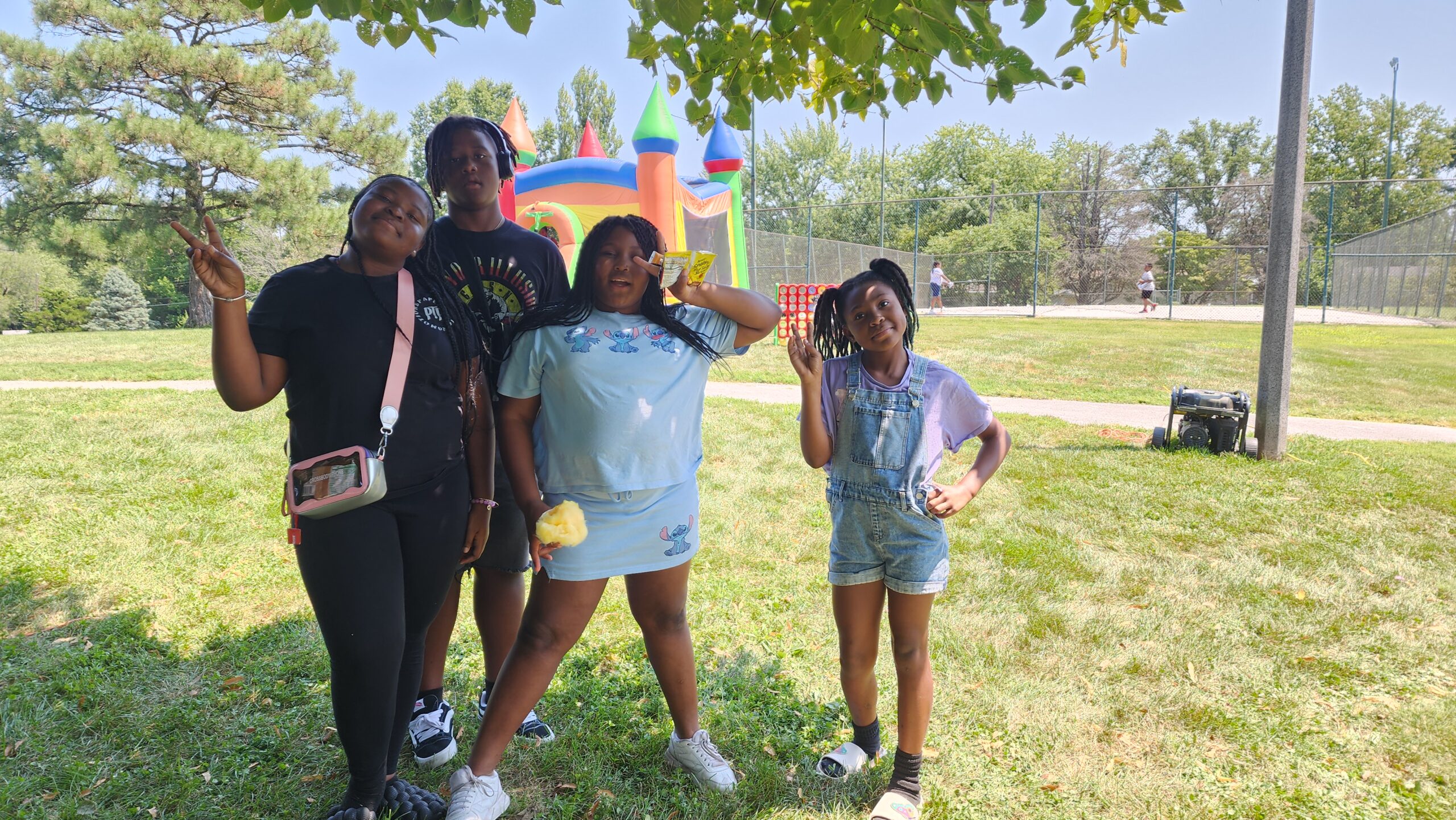 A group of people standing in the grass.