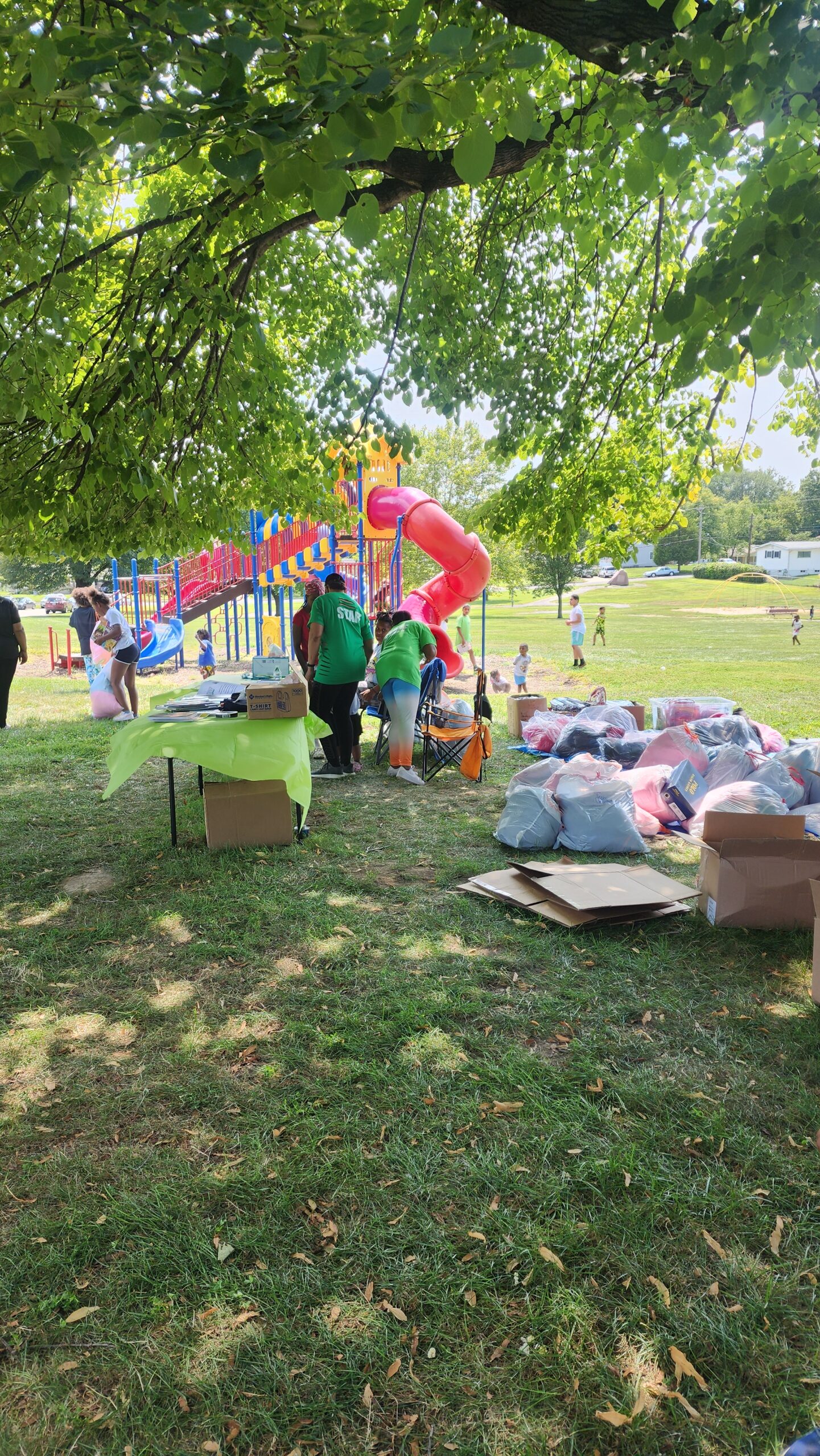 A group of people standing around some bags